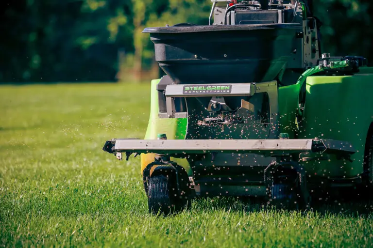 Pro-Mow Team spreading fertilizer on lawn.