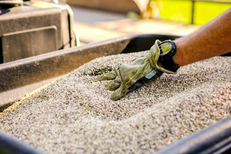 Pro-Mow working adding seeds to feeder.